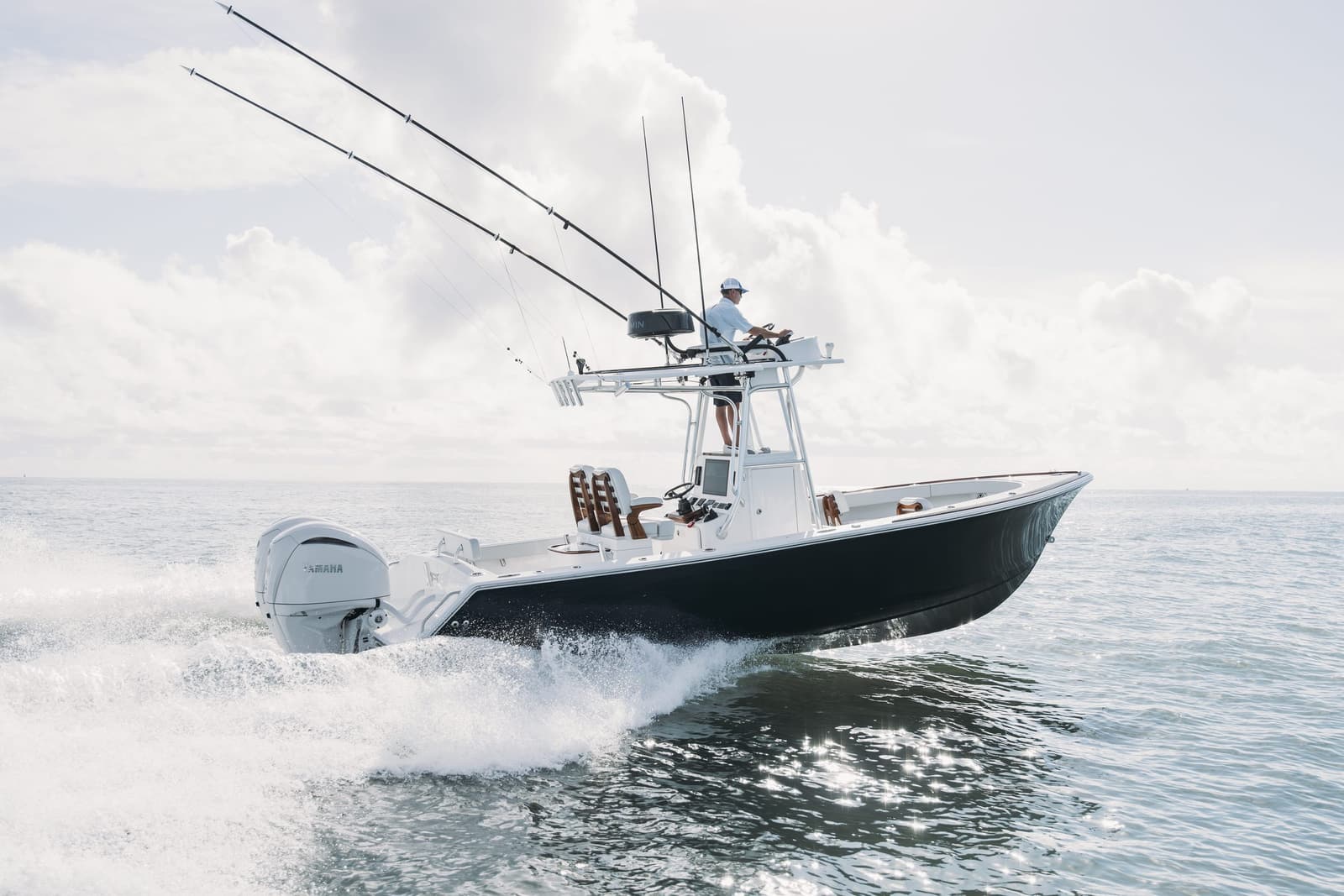 Blue hull Stuart 27 center console running across calm water