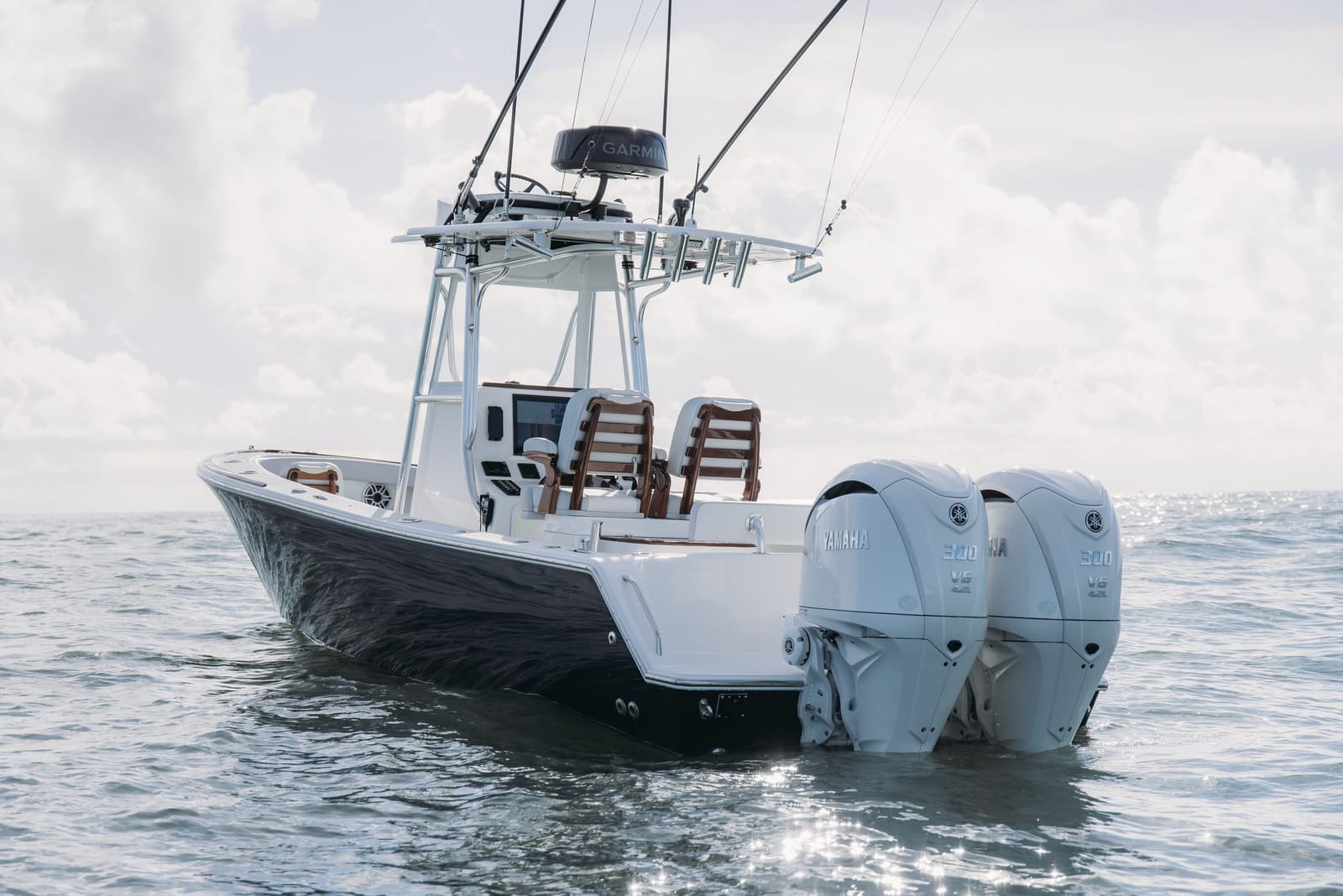 Stern of a blue hull Stuart 27 with twin outboards at rest