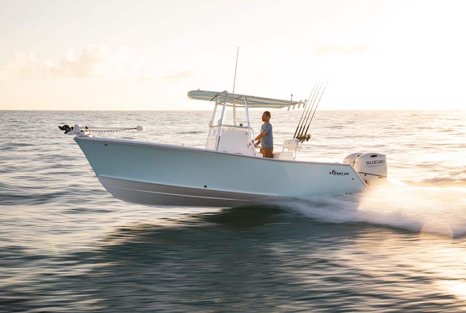 Stuart 23 with a folding T top running at sunset
