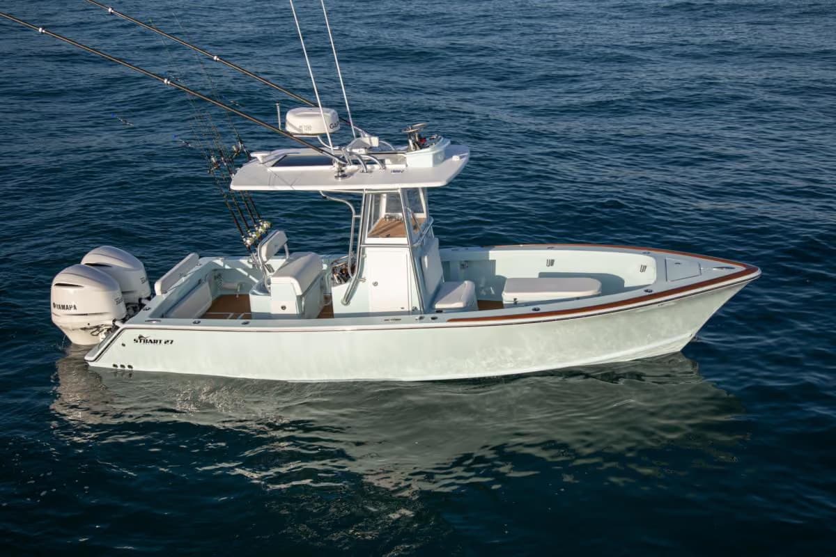 White Stuart 27 with a single outboard at rest at dusk